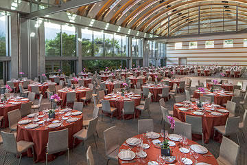 Round tables with chairs and place settings inside Guerin Pavilion