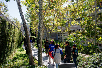 Group of students walking along outdoor path at the Skirball