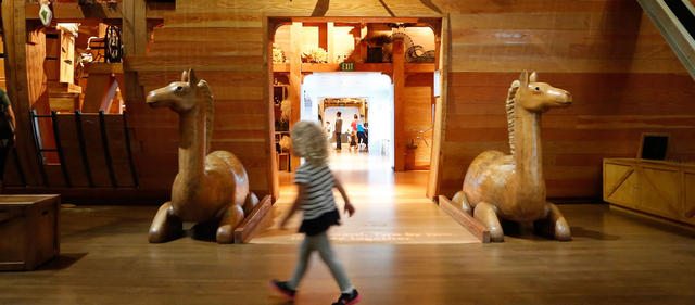 Girl walking in front of the entrance to the ark