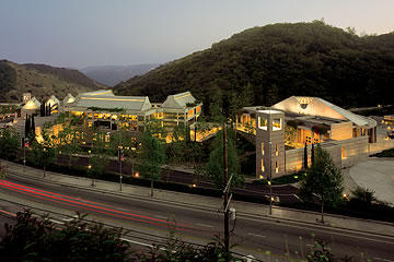 View of Skirball Cultural Center at dusk with freeway in foreground