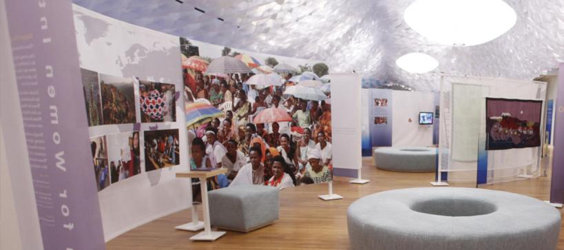 installation interior with photos of women on a curved wall