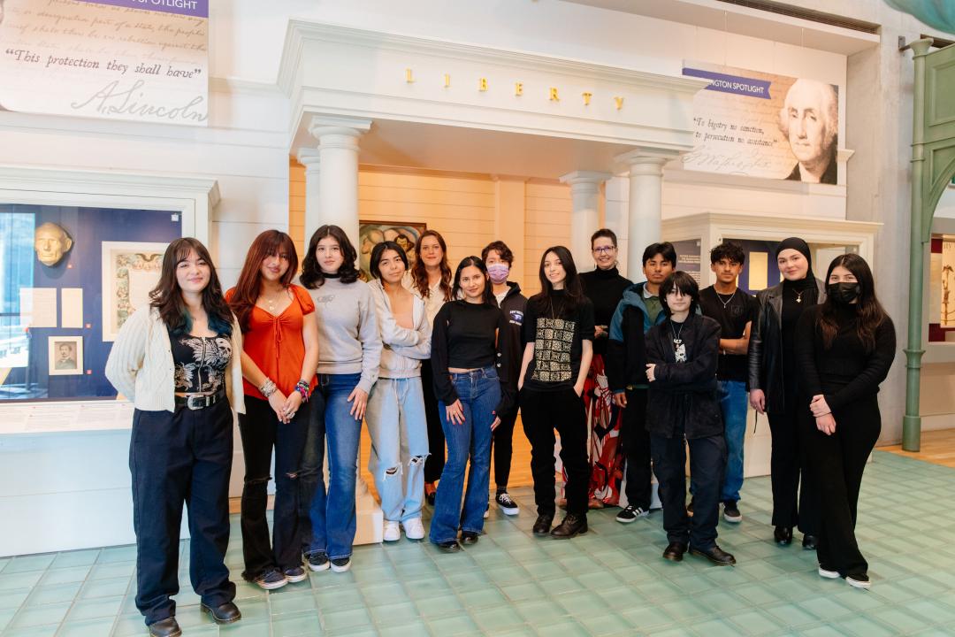 A group of students stands in the Visions & Values gallery.