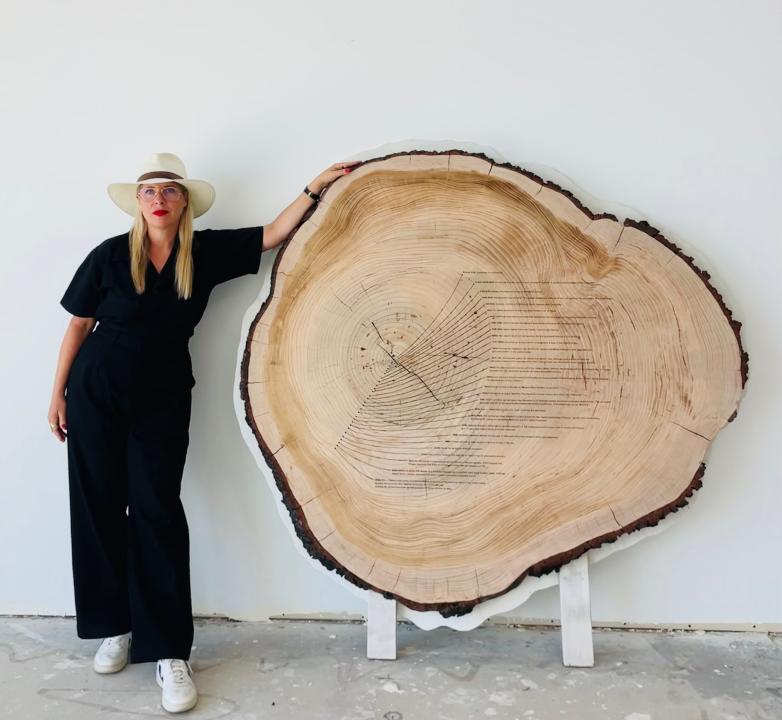 Artist Tiffany Shlain with Dendrofemonology tree ring.