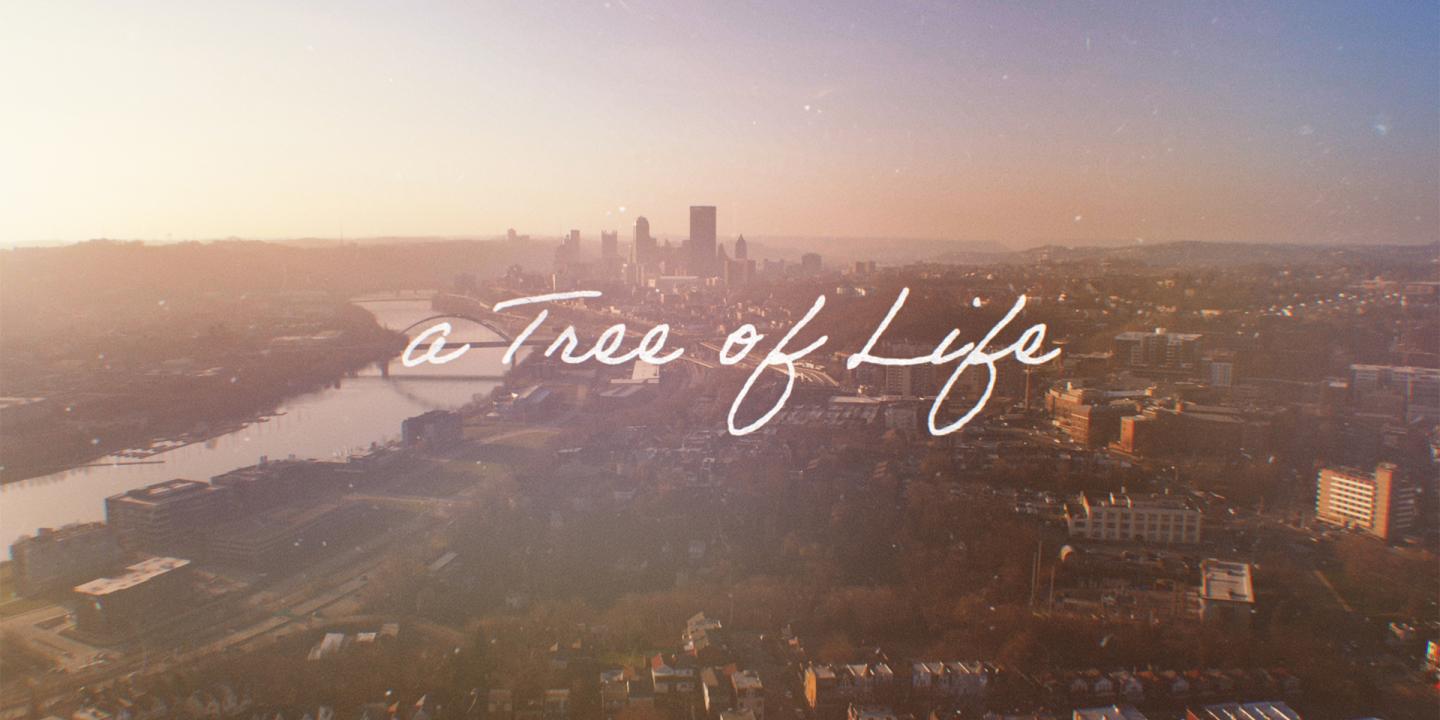 Ariel photo of the Pittsburg skyline with the words A Tree of Life in white script over it