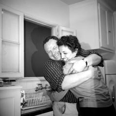 photo of a man hugging a woman in a kitchen