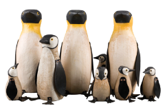 A family of nine penguins carved out wood standing together