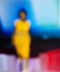 blurry image of a person wearing bright yellow