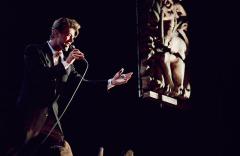 David Bowie singing, holding a microphone