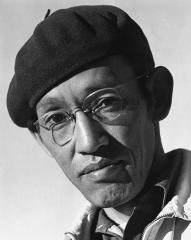 Close up of a man wearing a beret and glasses