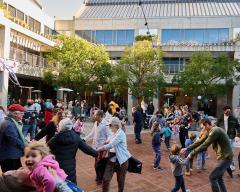 A large group of people dancing in Taper Courtyard