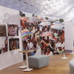 installation interior with photos of women on a curved wall