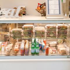 Deli case with an assortment of salads, beverages, and other items